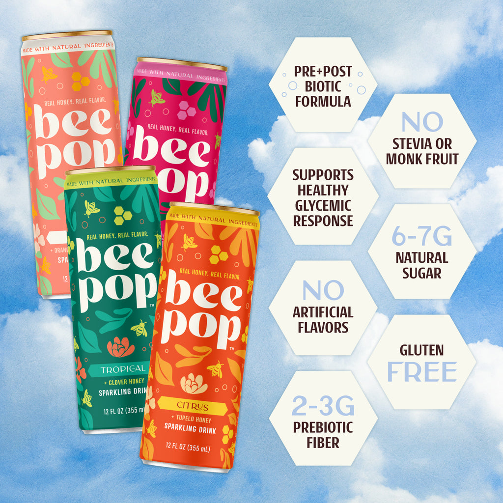 Four colorful cans of 'bee pop' sparkling drinks with health benefits text on a blue sky background